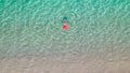 Top view. Young beautiful woman in a red hat and bikini swimming in sea water on the sand beach. Drone, copter photo. Summer Royalty Free Stock Photo