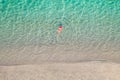 Top view. Young beautiful woman in a red hat and bikini swimming in sea water on the sand beach. Drone, copter photo. Summer Royalty Free Stock Photo