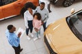 Top view of young black family buying or renting new car, speaking with salesman at auto dealership Royalty Free Stock Photo