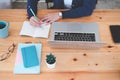 Top View of young business woman working in cafe. On table is laptop,cup of coffee, mobile phone, notebook. Entrepreneur working Royalty Free Stock Photo