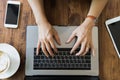 Top view young businesswoman hand using laptop on wooden table. Royalty Free Stock Photo