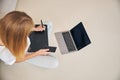 Blonde girl working on her graphics tablet on the floor Royalty Free Stock Photo