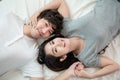 Top view of young lovely Asian couple lying in a bed and smiling Royalty Free Stock Photo