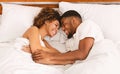 Top view on young loving black couple lying in bed Royalty Free Stock Photo
