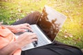Top view of young man sitting in park on green grass with laptop Royalty Free Stock Photo