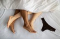 Top view of young multiracial couple making love on bed, cute panties lying nearby Royalty Free Stock Photo