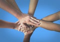 Close up top view of young people putting their hands together. Friends with stack of hands showing unity and teamwork. Royalty Free Stock Photo