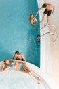 Top view - young people relax in swimming pool