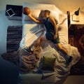 Top view of young professional basketball player sleeping at his bedroom in sportwear with ball