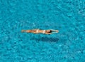 Top view of young slim woman in white bikini relax and floating in infinity swimming pool Royalty Free Stock Photo