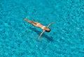 Top view of young slim woman in white bikini relax and floating in infinity swimming pool Royalty Free Stock Photo