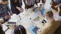 Top view of young team working on architectural project. Group of mixed race people standing near table and discussing. Royalty Free Stock Photo