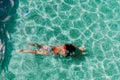 Top view of young woman diving underwater in a pool. summer and fun lifestyle Royalty Free Stock Photo