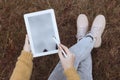 Top view of young woman drawing with graphic tablet outdoors, closeup Royalty Free Stock Photo