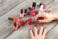 Top view on young woman hands, applying second red coat of nail Royalty Free Stock Photo