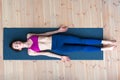 Top view of young woman lying in corpse or dead body pose relaxing after practicing yoga Royalty Free Stock Photo