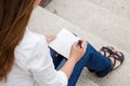 Top view of young woman making notes in notebook Royalty Free Stock Photo