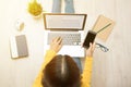 Top view of young woman sitting on the floor using laptop Royalty Free Stock Photo