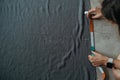 Top view of a young woman tailor marking a pattern on fabric using a chalk Royalty Free Stock Photo