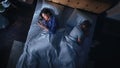 Top View: Young Woman Uses Smartphone in Bed at Night When Her Male Partner Trying to Fall Asleep