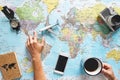 Top view of young woman planning her vacation using world map while drinking coffee - Tourist pointing the next travel destination Royalty Free Stock Photo