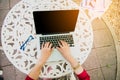 Top view of young working woman using laptop and reading annual report document at work. Business woman working at her desk Royalty Free Stock Photo