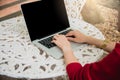 Top view of young working woman using laptop and reading annual report document at work. Business woman working at her desk Royalty Free Stock Photo