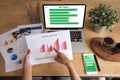 Top view of young working woman using laptop and reading annual report document at work. Business woman working at her desk Royalty Free Stock Photo