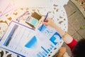 Top view of young working woman using laptop and reading annual report document at work. Business woman working at her desk Royalty Free Stock Photo