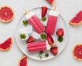 top view yummy popsicles plate with red grapefruit. High quality photo