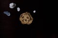 Top view of Zen Pile of chocolate Chips with a stones pile in the back and dark background