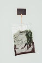 top view of ziplock plastic bag with dried plants, soil and blackboard