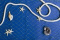 Top viewq of marine net, seashells, starfish and rope on the dark blue background.Free space for design in the middle of image Royalty Free Stock Photo