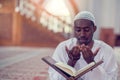 Top viewv of African Muslim Man Making Traditional Prayer To God While Wearing A Traditional Cap Dishdasha