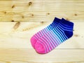Blue and pink stripes sock on wooden background Royalty Free Stock Photo