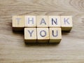 Thank you word wooden block on wooden background