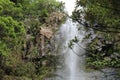 The top of Wailua Falls plummeting down a rocky cliff surrounded by lush vegetation in Hana, Maui Royalty Free Stock Photo