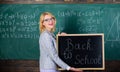 Top ways to welcome students back to school. Teacher woman hold blackboard inscription back to school. It is school time Royalty Free Stock Photo