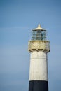 Top of a white lighthouse tower with a fixed Fresnel Lens Royalty Free Stock Photo