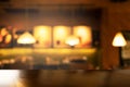 Top of wood table with blur three lamp in bar cafe and restaurant at night interior background Royalty Free Stock Photo