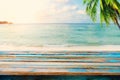 Top of wood table on blurred sea with coconut tree background Royalty Free Stock Photo