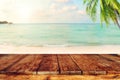 Top of wood table on blurred sea with coconut tree background Royalty Free Stock Photo