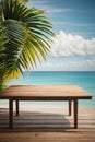 Top of wood table with seascape and palm leaves, blur bokeh light of calm sea and sky at tropical beach background. Empty ready fo Royalty Free Stock Photo