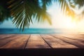 Top of wood table with seascape and palm leaves, tropical beach background Royalty Free Stock Photo