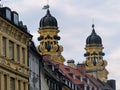 Yellow baroque bell towers of the church of `Theatinerkirche`to Munich in Germany.