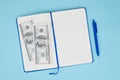 Topa above close up view photo of opened notebook with budget sum 200 dollars isolated pastel blue background