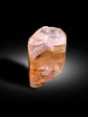 Topaz sherry color crystal with etched textured on surface isolated on black shaded background crystal from skardu pakistan