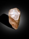 Topaz sherry color crystal with etched textured on surface isolated on black shaded background crystal from skardu pakistan