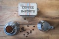 Topdown shot of coffee canister surrounded by a Bialetti and some coffee beans