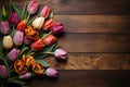 Topdown view Blank paper card and vibrant tulip bouquet on wood